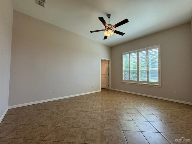 tiled spare room with ceiling fan