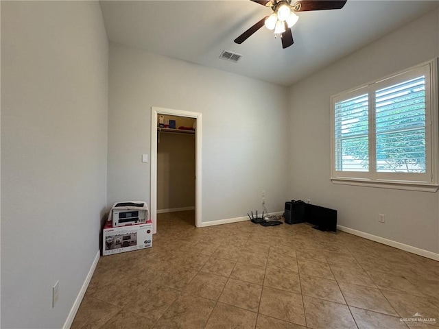 spare room with ceiling fan and light tile patterned floors