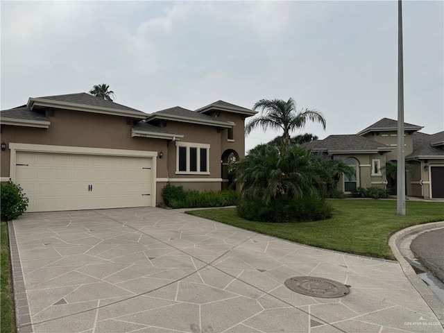 view of front facade featuring a garage and a front lawn