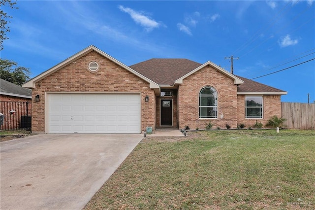 3621 Xenops Ave, Mcallen, TX 78504 - ranch-style house with a garage, brick siding, fence, a front lawn, and concrete driveway