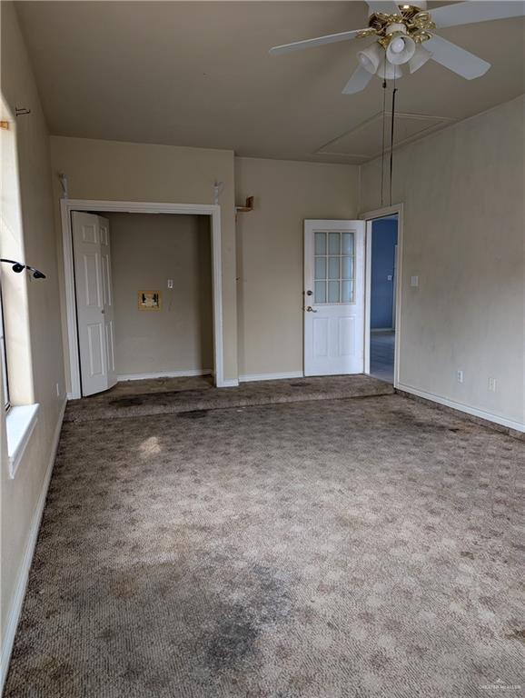 unfurnished room with carpet, baseboards, and ceiling fan