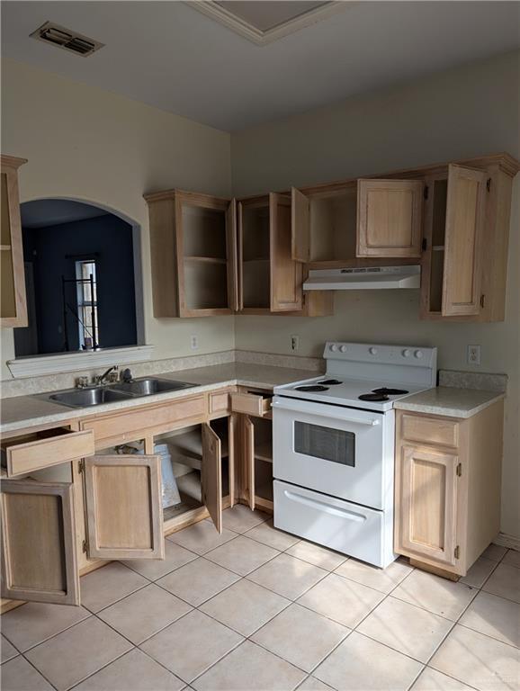 kitchen with white range with electric stovetop, visible vents, light brown cabinetry, under cabinet range hood, and a sink