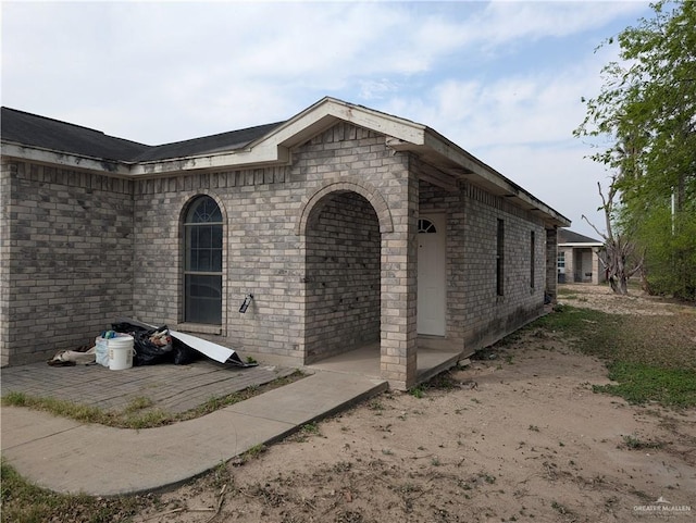 doorway to property with brick siding