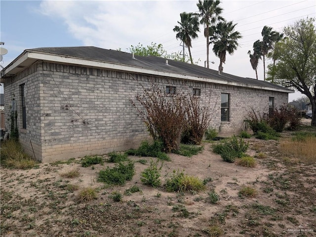 view of property exterior featuring brick siding