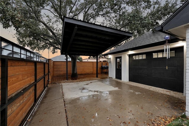 view of garage at dusk