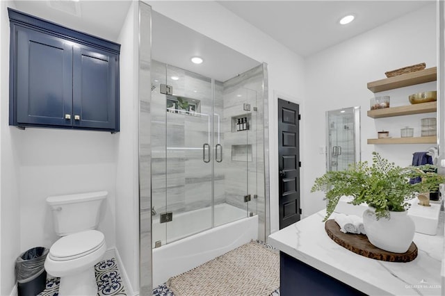 full bathroom featuring toilet, tile patterned floors, shower / bath combination with glass door, and vanity