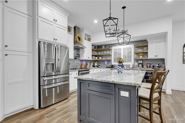 kitchen with white cabinets, a kitchen island, and stainless steel refrigerator with ice dispenser