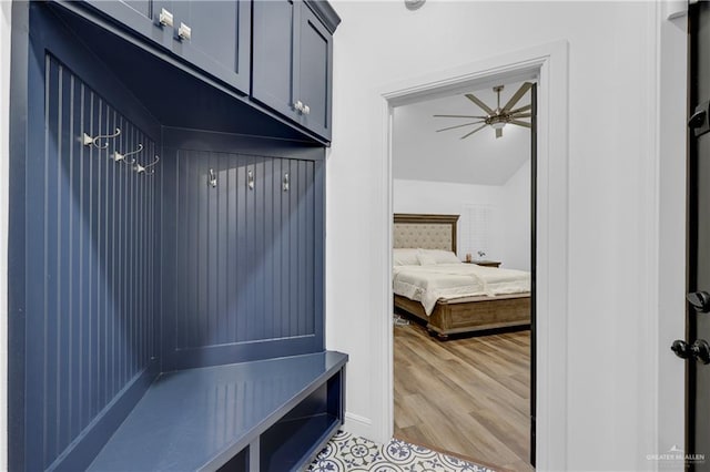 mudroom featuring lofted ceiling, light wood-type flooring, and ceiling fan