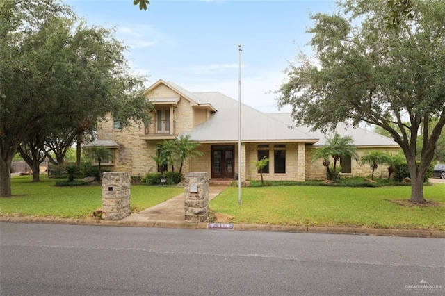 view of front facade featuring french doors and a front lawn