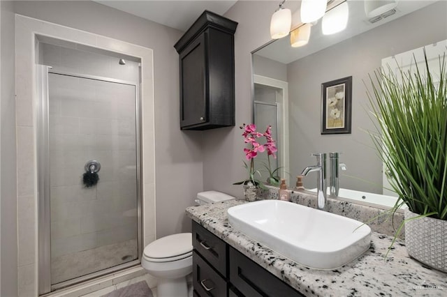 bathroom featuring vanity, toilet, and an enclosed shower