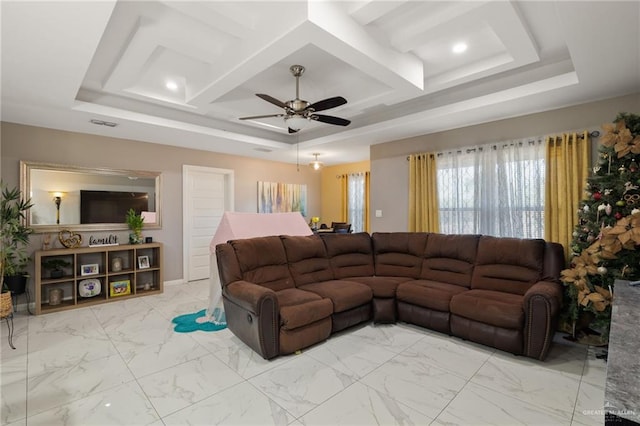 living room with ceiling fan and coffered ceiling