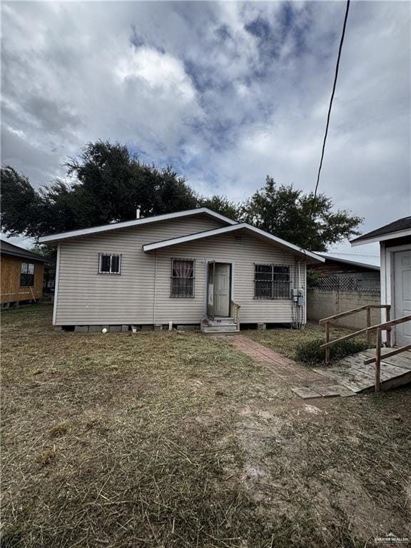 back of house with a lawn