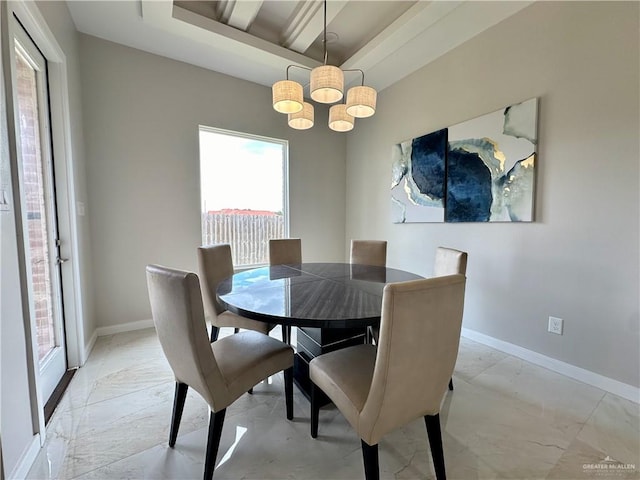 dining space featuring a tray ceiling and an inviting chandelier