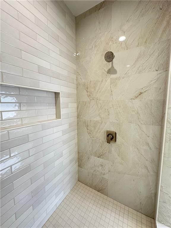 bathroom with a tile shower