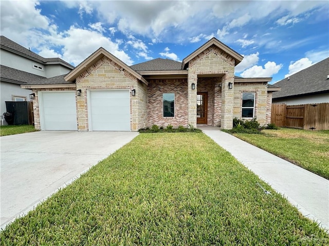 view of front of property with a garage and a front lawn