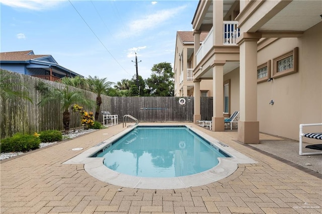 123 E Saturn Ln Unit C-3, South Padre Island, TX 78597 - community pool with a fenced backyard and a patio area