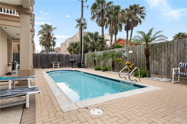 123 E Saturn Ln Unit C-3, South Padre Island, TX 78597 - view of swimming pool featuring a patio area and a fenced backyard