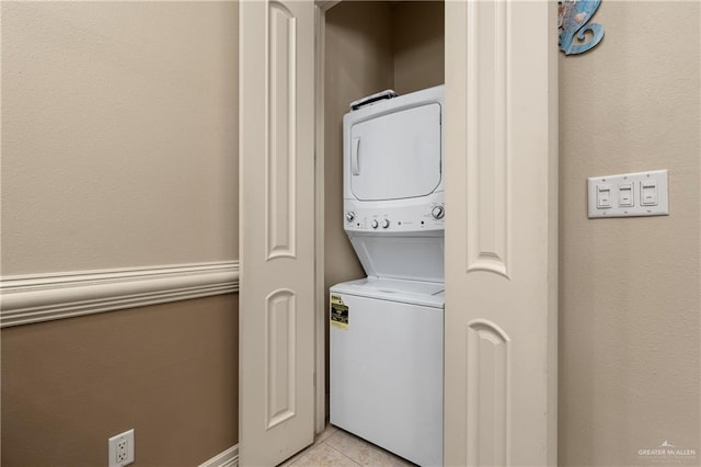 123 E Saturn Ln Unit C-3, South Padre Island, TX 78597 - washroom with estacked washer and dryer and light tile patterned flooring