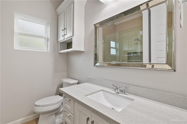 bathroom featuring vanity, toilet, and walk in shower