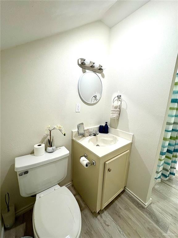 full bathroom featuring vanity, toilet, baseboards, curtained shower, and wood finished floors