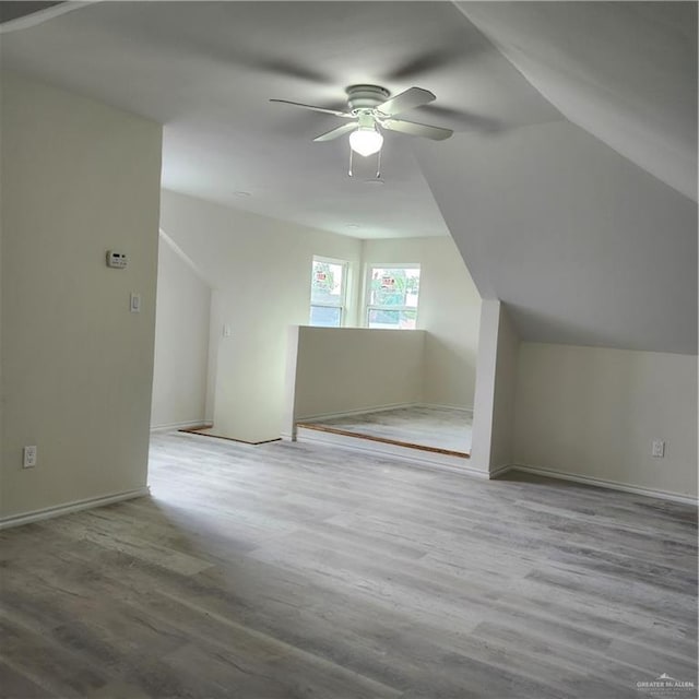 additional living space with lofted ceiling, ceiling fan, and wood finished floors