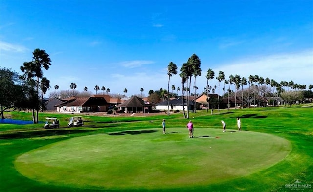 view of home's community with a lawn and golf course view