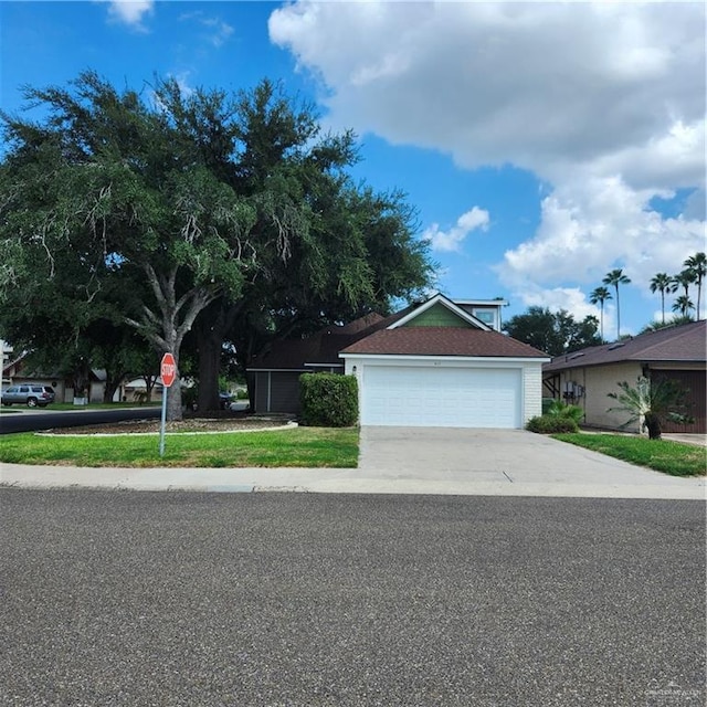 view of front facade with concrete driveway and a garage