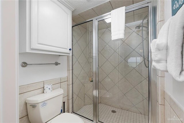 3000 Gulf Blvd Unit 701, South Padre Island, TX 78597 - bathroom with tile walls and a stall shower
