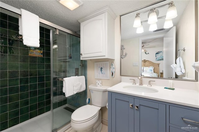 3000 Gulf Blvd Unit 701, South Padre Island, TX 78597 - full bathroom featuring vanity, a stall shower, ensuite bath, a textured ceiling, and a ceiling fan