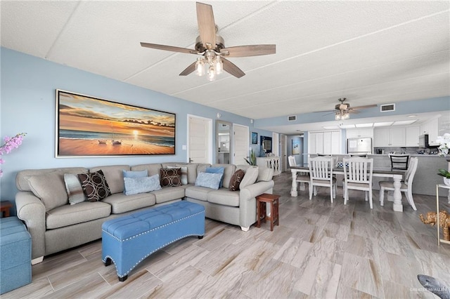 3000 Gulf Blvd Unit 701, South Padre Island, TX 78597 - living room with a ceiling fan and light wood-type flooring