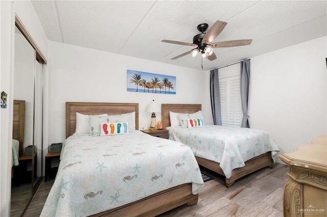 3000 Gulf Blvd Unit 701, South Padre Island, TX 78597 - bedroom featuring a closet, wood finished floors, ceiling fan, and a textured ceiling