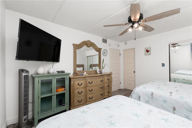 3000 Gulf Blvd Unit 701, South Padre Island, TX 78597 - bedroom featuring ceiling fan, wood finished floors, and a textured ceiling