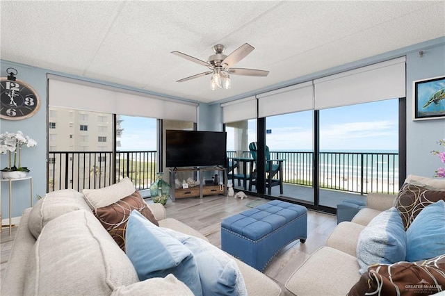 3000 Gulf Blvd Unit 701, South Padre Island, TX 78597 - living area with wood finished floors, a ceiling fan, and a textured ceiling