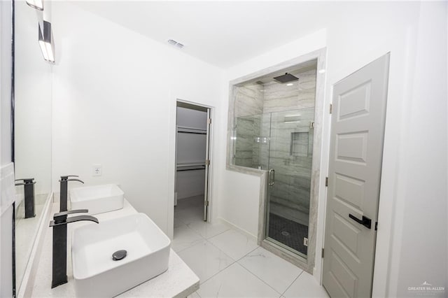 bathroom featuring vanity and a shower with door