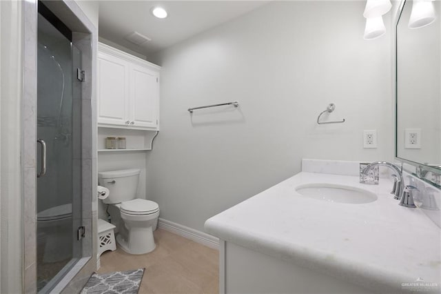 bathroom featuring vanity, toilet, and walk in shower