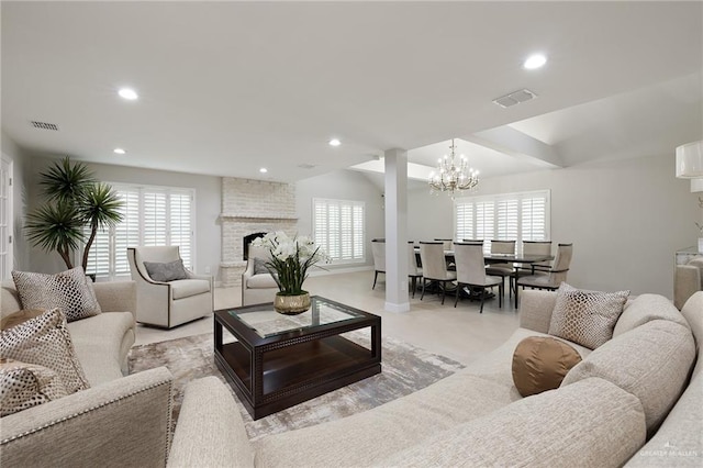 carpeted living room with a wealth of natural light, a fireplace, and a chandelier