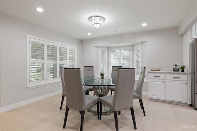 dining room featuring a healthy amount of sunlight and a notable chandelier