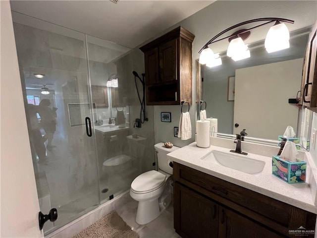 bathroom featuring vanity, toilet, and walk in shower