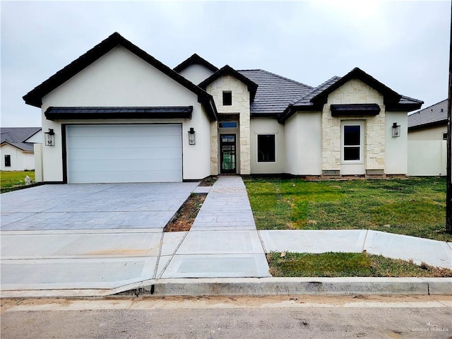 view of front of house with driveway, stone siding, stucco siding, a front lawn, and a garage