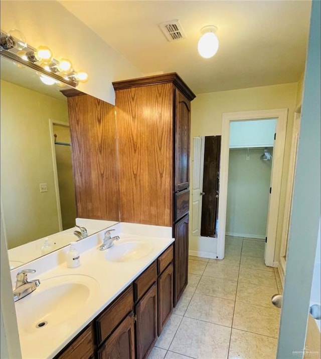 bathroom with tile patterned flooring and vanity