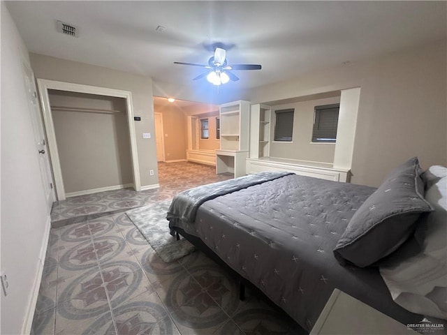 tiled bedroom featuring ceiling fan and a closet