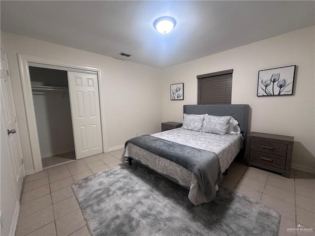 tiled bedroom featuring a closet