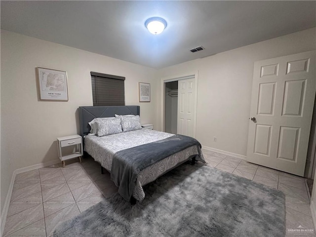 tiled bedroom featuring a closet