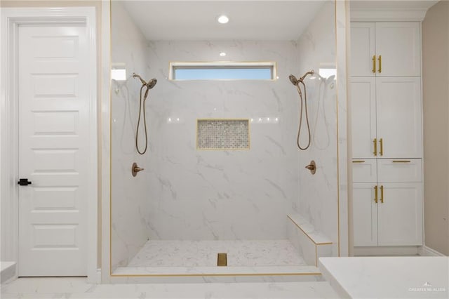 bathroom with tiled shower