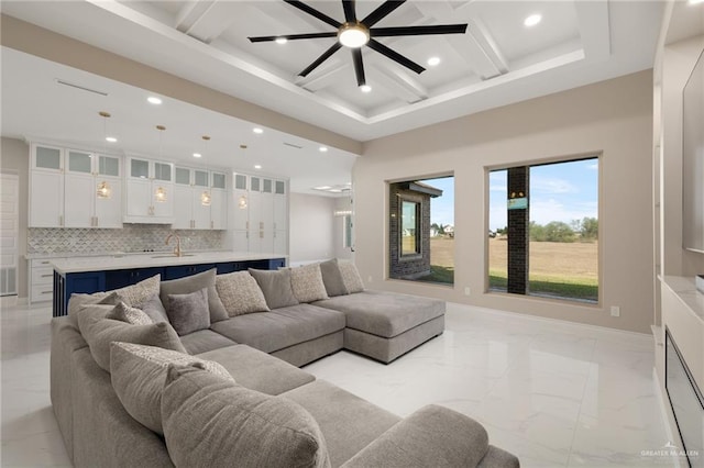 living room featuring sink, beamed ceiling, and coffered ceiling