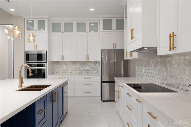 kitchen featuring light stone counters, blue cabinetry, white cabinetry, and appliances with stainless steel finishes