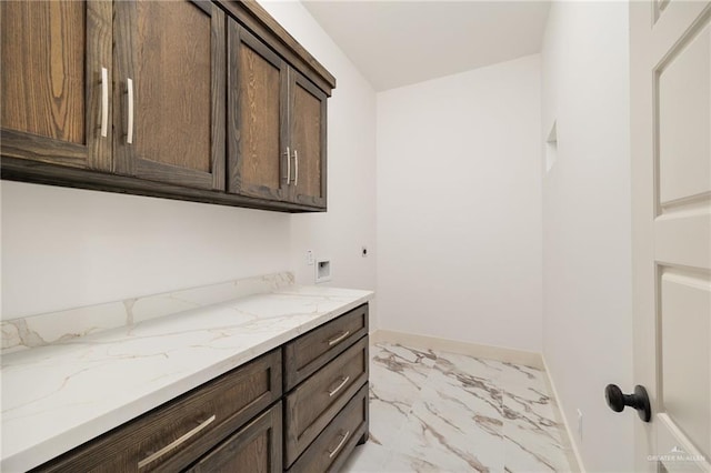 washroom featuring hookup for an electric dryer, cabinets, and washer hookup