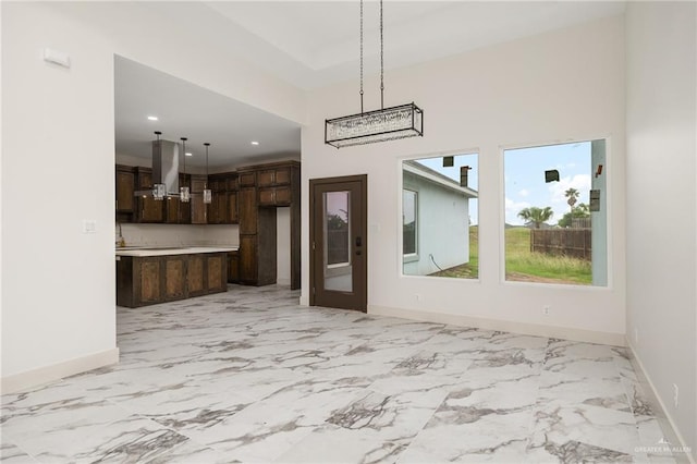 unfurnished dining area featuring a high ceiling