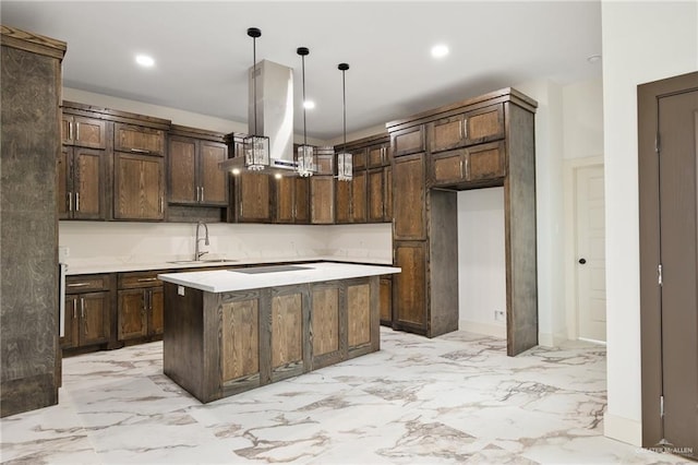 kitchen featuring sink, hanging light fixtures, a kitchen island, island range hood, and dark brown cabinetry