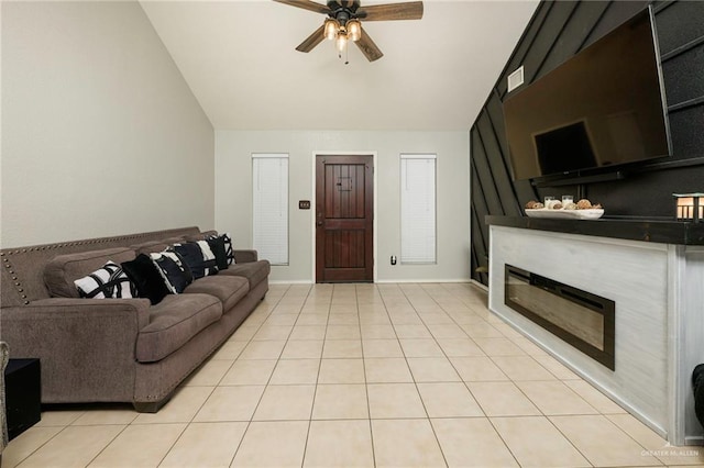 living room with lofted ceiling, light tile patterned floors, and ceiling fan